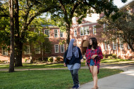Two Beloit College students walk between classes near Morse-Ingersoll Hall.