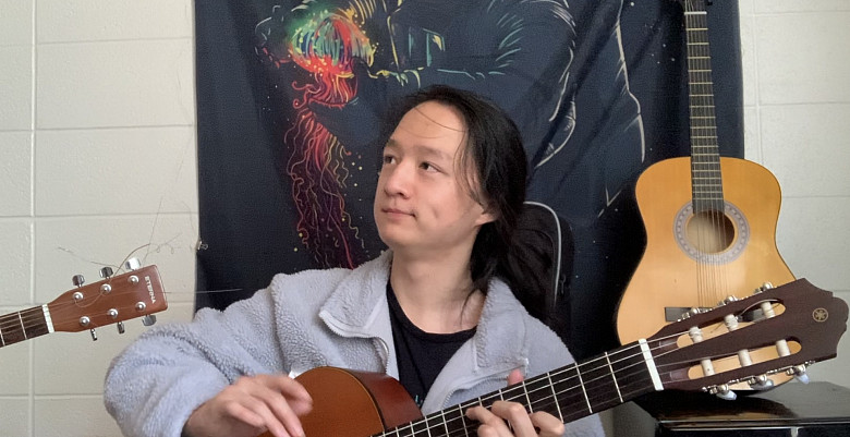 Tianlong Ethan Wang'23 playing the guitar