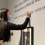 Midori Tanada ’23 touches up the vinyl for the exhibit done by students in Susan Furukawa’s “Narratives of War and Peace” Japanese class.