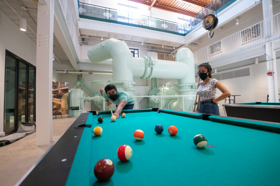 Students playing pool in the lower level of the Powerhouse.